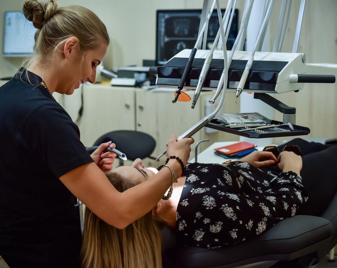 A dentist and a woman wearing a floral top