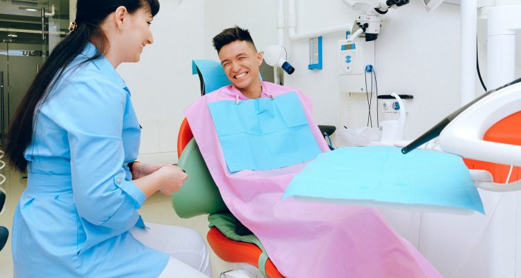 A dentist and patient smiling