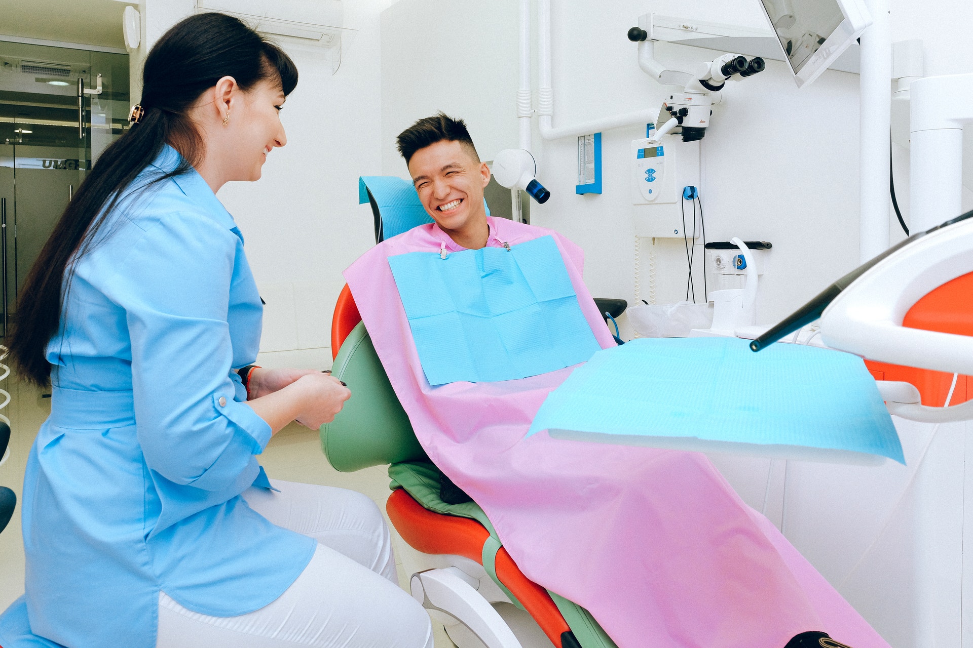 A dentist and patient smiling